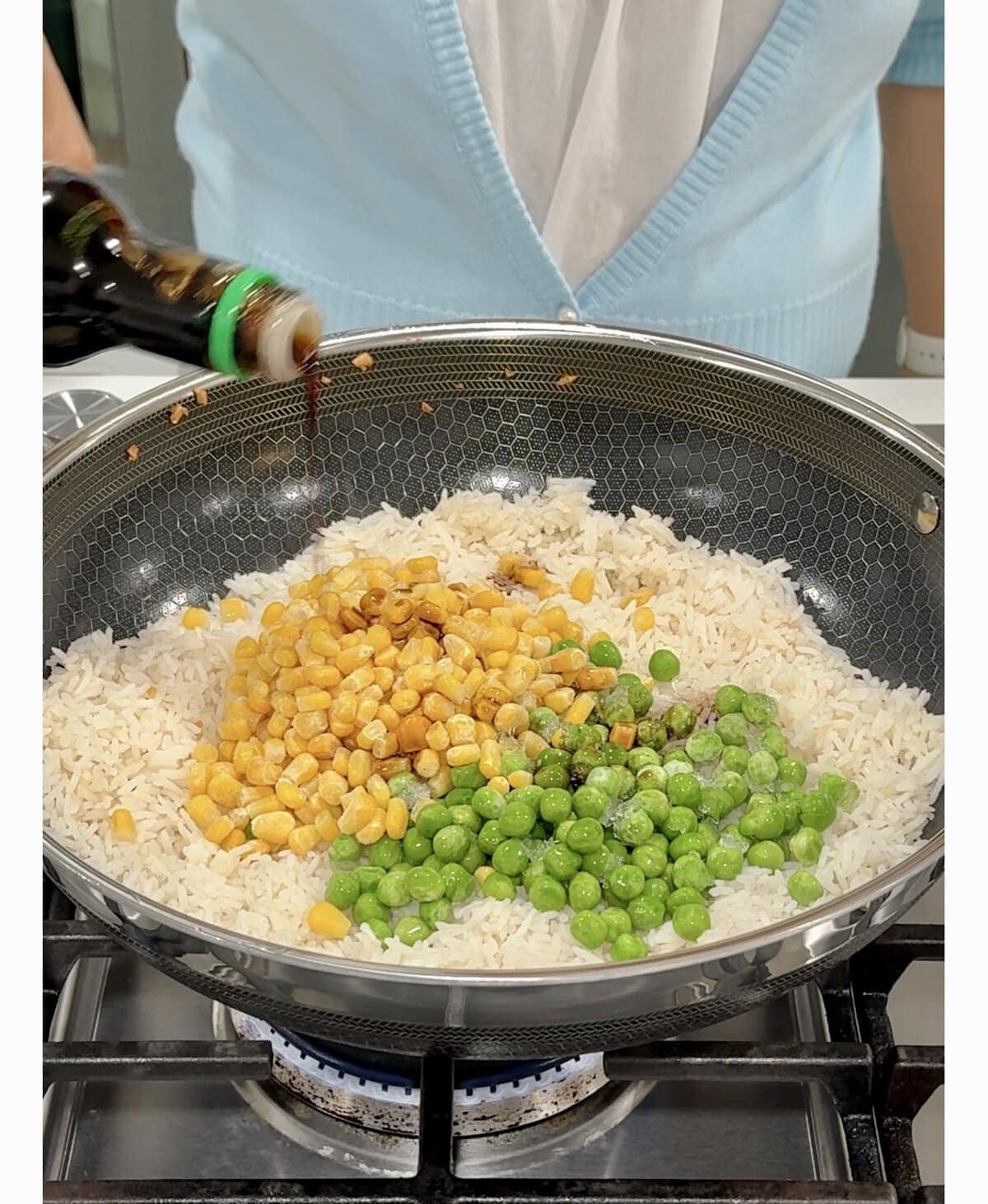 adding vegetables to fried rice.