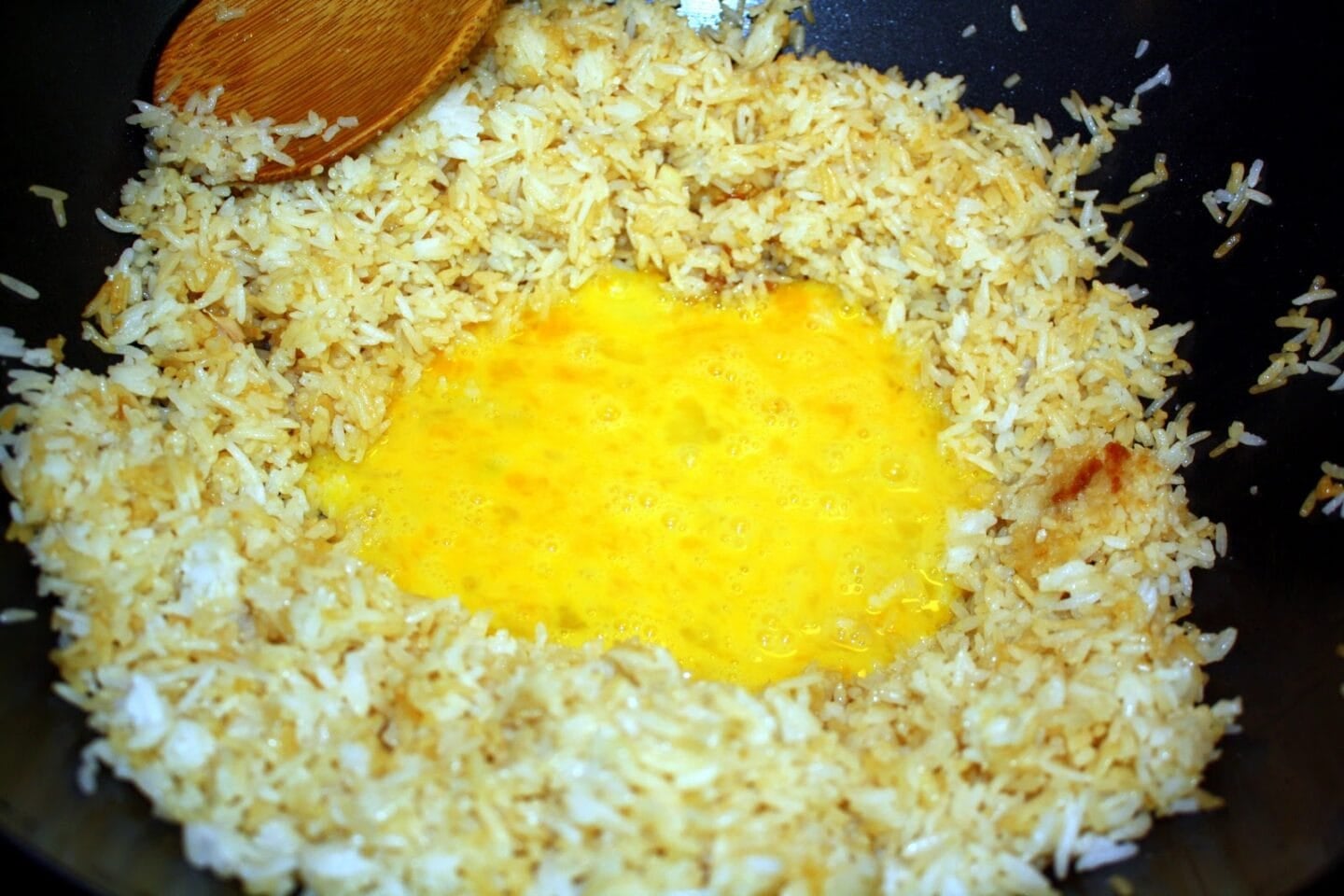 eggs being mixed with rice.