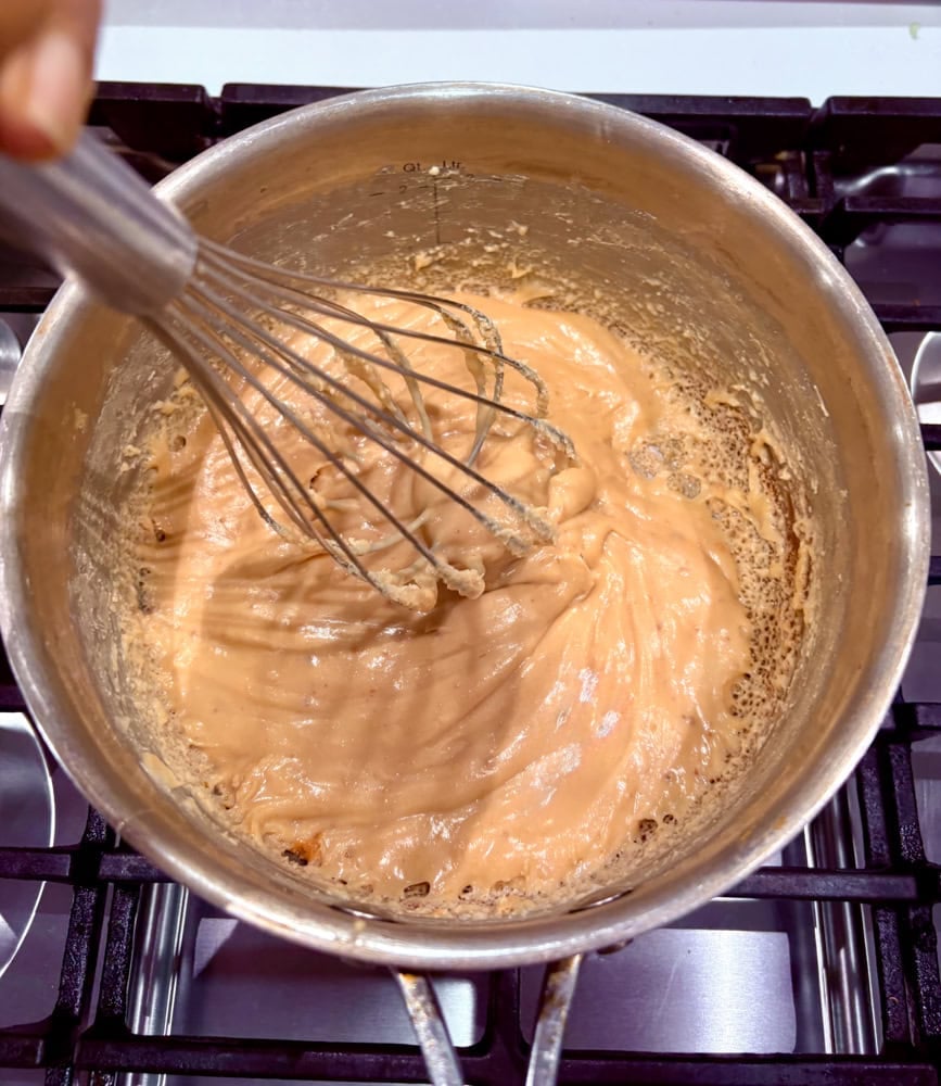 Once bubbling, stir continuously for 6-8 minutes (use a timer) on low heat until it thickens, darkens slightly to a golden caramel color, and coats the back of a spoon (it should still be pourable but leaves a visible trail).