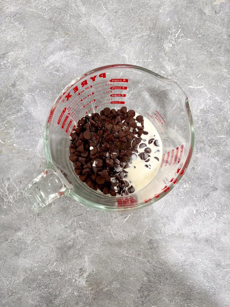 Heat the heavy cream, corn/maple syrup, and chocolate chips together in a small saucepan or microwave until hot and beginning to melt (do not boil).