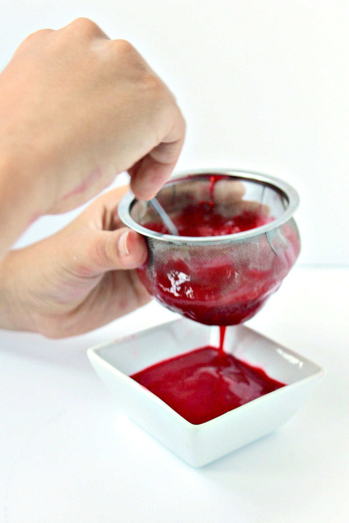 Need a delicious fruity topping for your dessert? This versatile, quick and easy 2-Ingredient Raspberry Coulis (sauce) is perfect for cheesecakes, ice creams, waffles, pancakes and so much more. Straining Raspberry Sauce