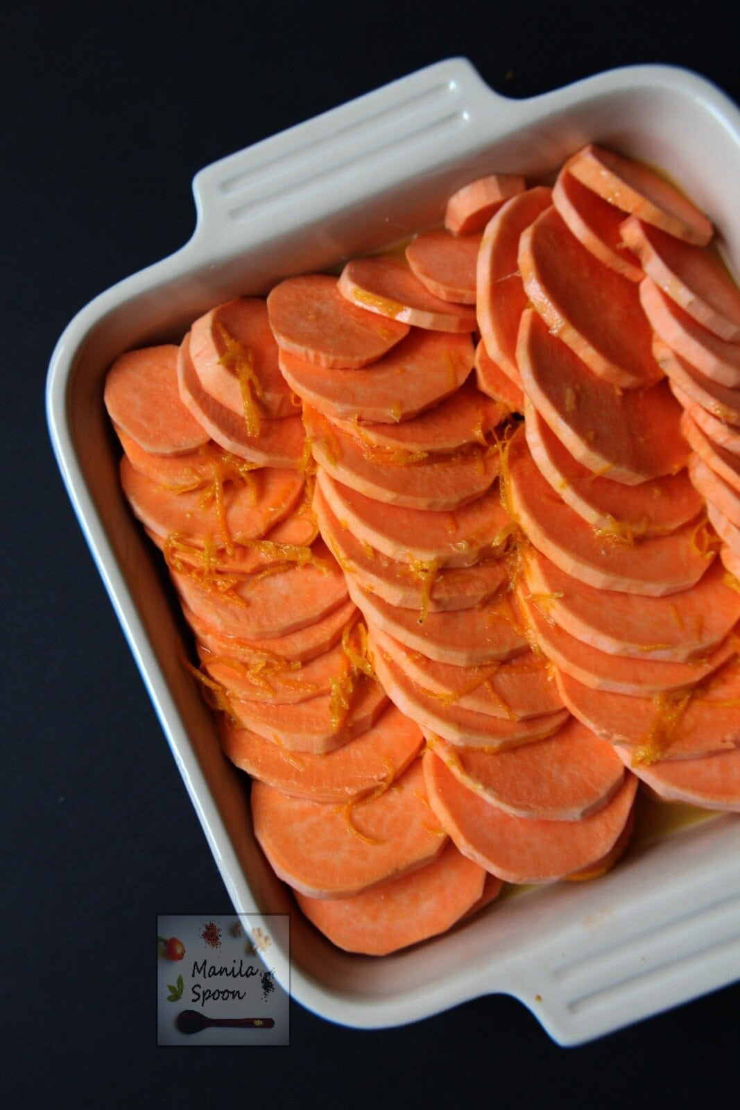 a mixture of honey, orange juice and zest, butter and a little salt poured over the sliced sweet potatoes