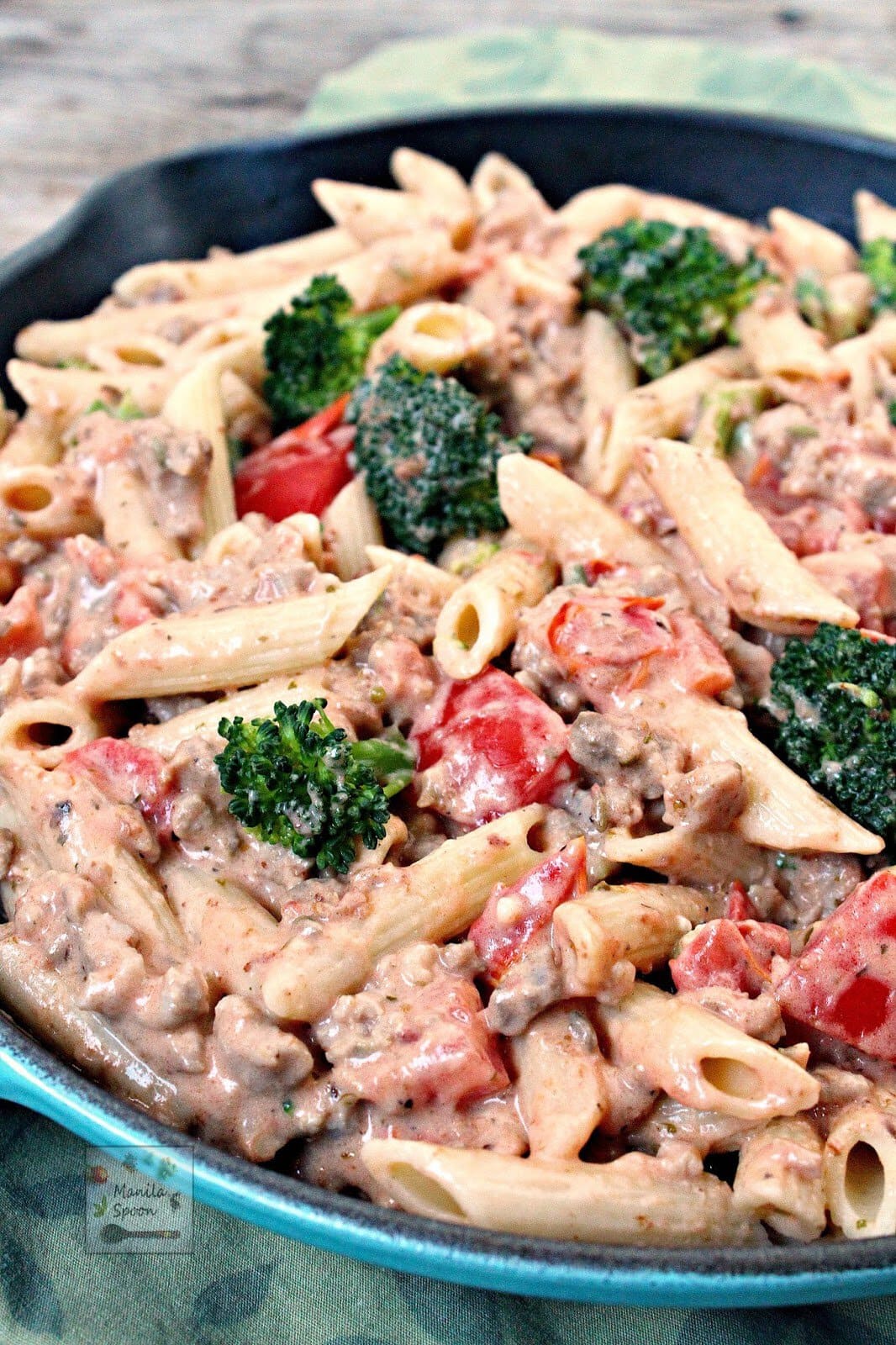 Italian Sausage and Broccoli Alfredo Pasta in a cast iron pan.