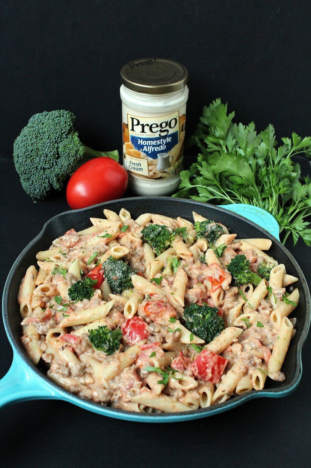 Italian Sausage and Broccoli Alfredo Pasta in a cast iron pan.