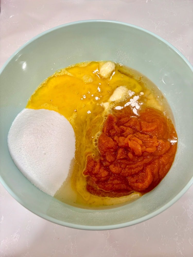 Add the pumpkin puree, sugar, eggs, and oil.