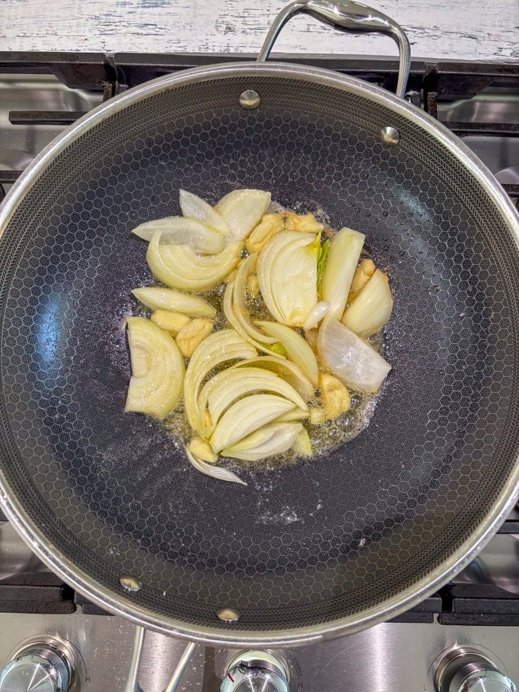 Sauté the garlic and onions in the melted butter until aromatic, about 1 minute.