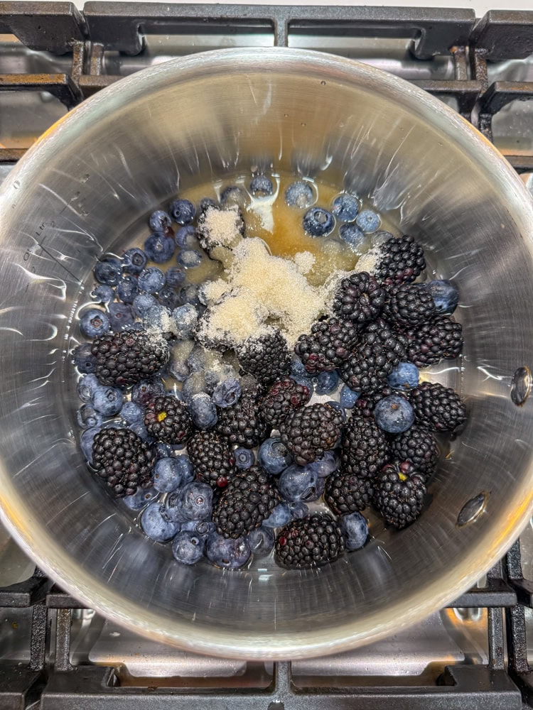 In a large saucepan, combine the berries, water, and remaining sugar. Bring to a boil.
