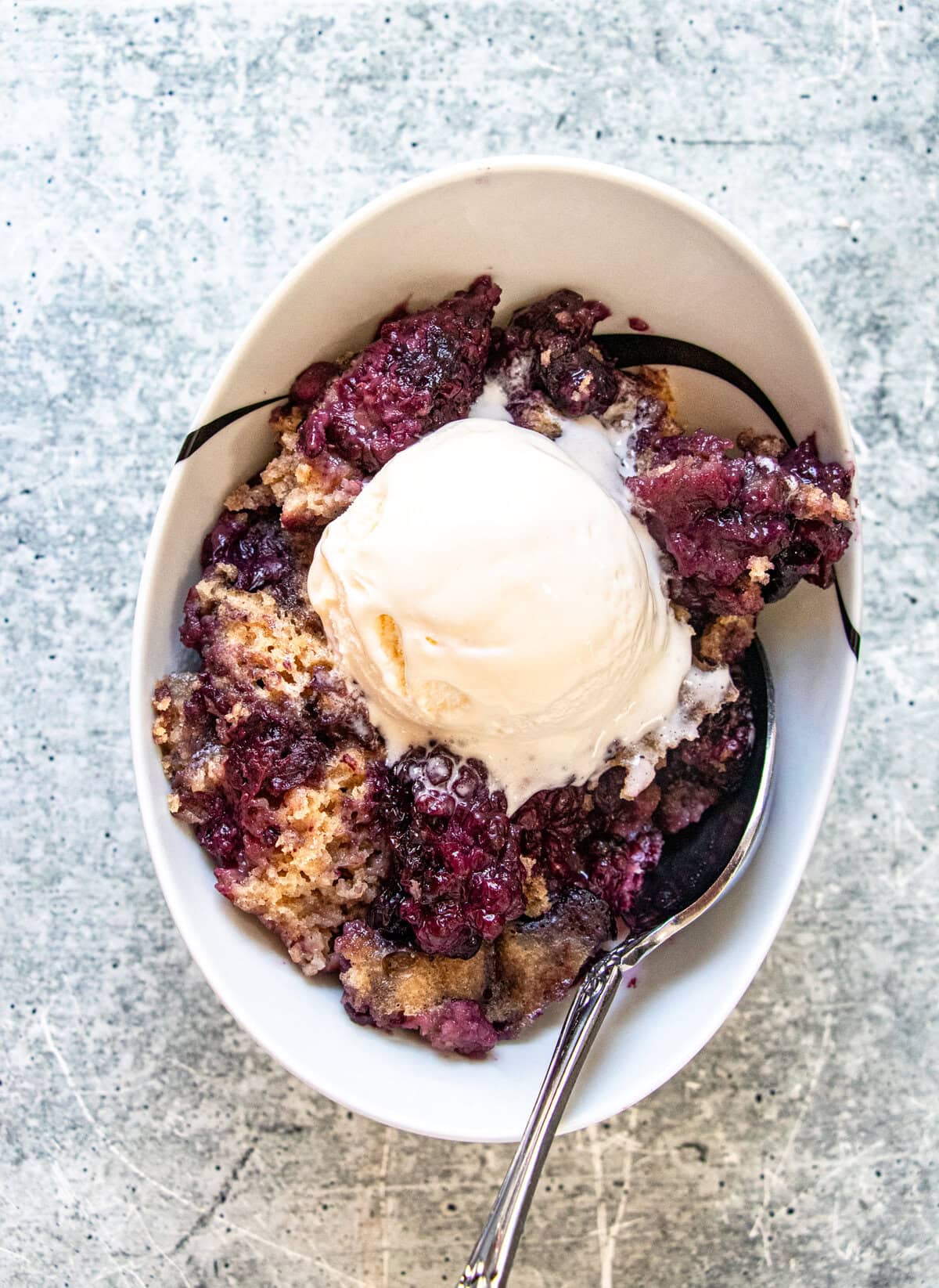 Slow Cooker Blackberry Cobbler with juicy berries and warmly spiced cake topping.