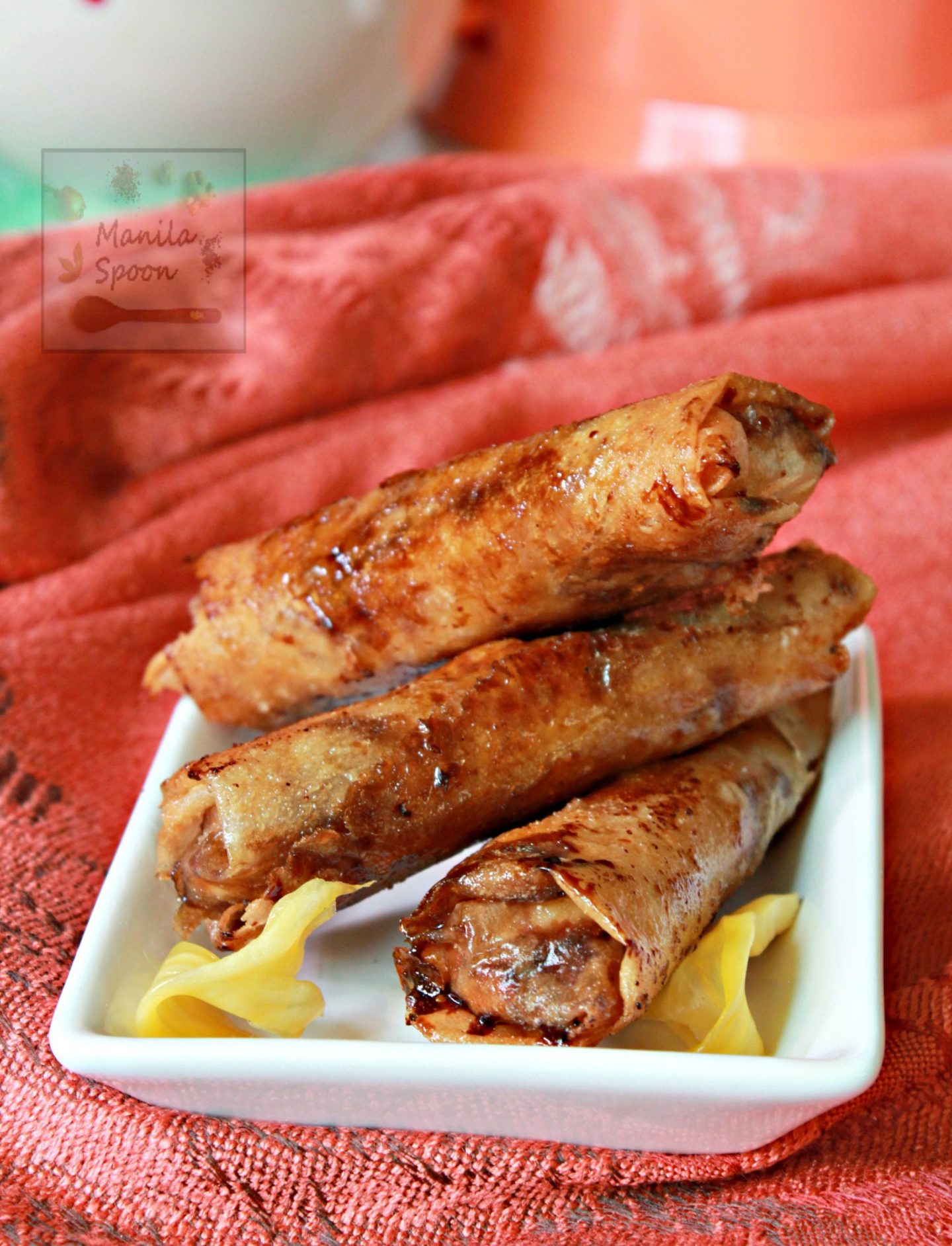 These Banana Spring Rolls or Lumpia - Turon - are the best way to use up all that ripe Bananas. Bananas are rolled in sugar and then wrap in spring roll wrappers with slices of jackfruit then cooked until perfectly crispy. This delicious caramelized Asian classic snack or dessert is a must-make. #turon #bananalumpia #bananaspringrolls #lumpia