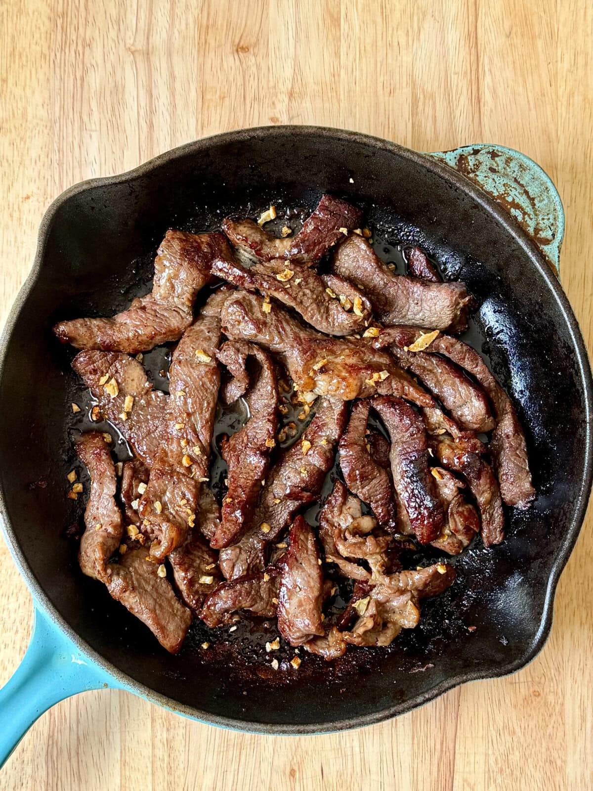 Beef Salpicao (Filipino Garlic and Butter Steak Bites) in a cast iron skillet
