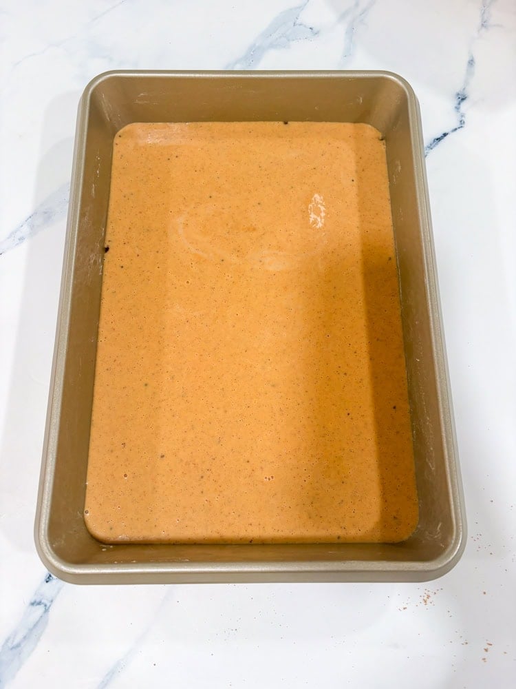 Pour the pumpkin mixture over the crust and spread to the edges.