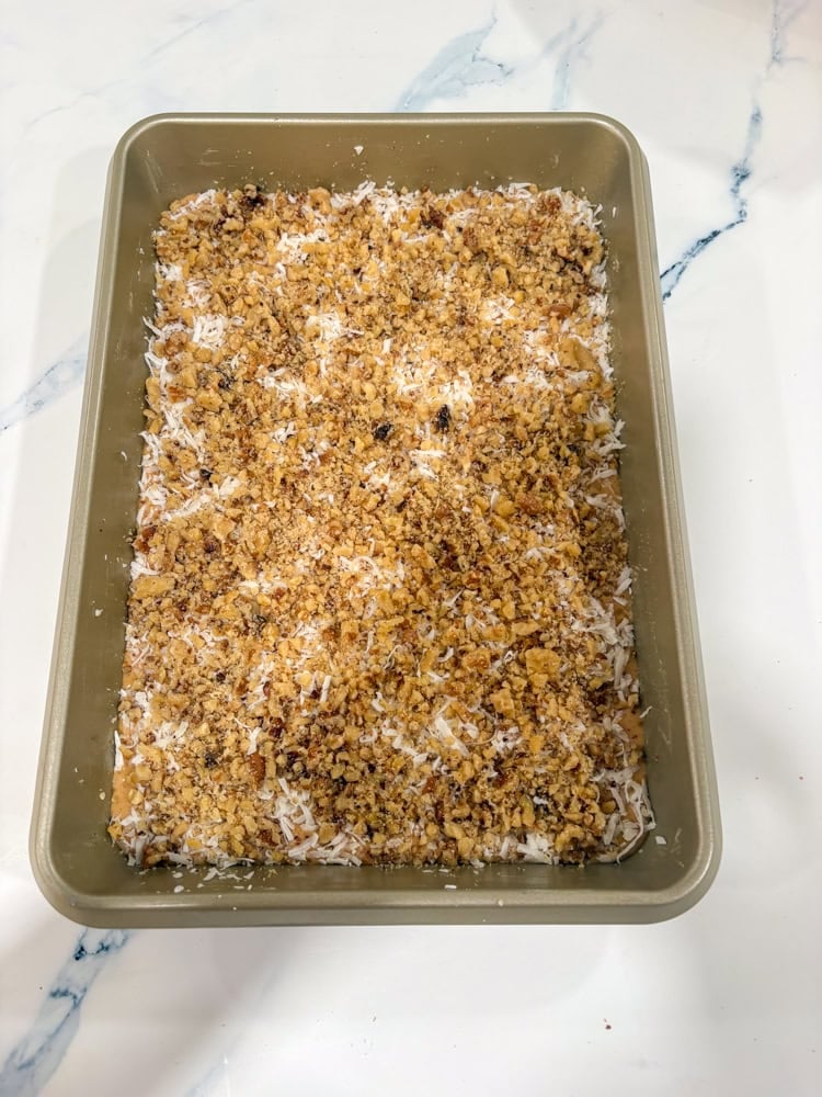 Sprinkle 1 cup coconut evenly over the top. Add nuts and chocolate chips.