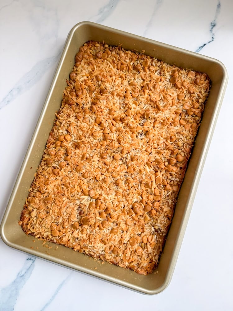 The classic favorite magic bars get a fall-inspired make-over with the addition of pumpkin puree and pumpkin pie spice in these Easy Magic Pumpkin Bars. So yummy and most of all crazy easy to make! 7 layers of deliciousness with every bite of this scrumptious fall dessert! The classic magic bar with a fall makeover: pumpkin magic Bars!