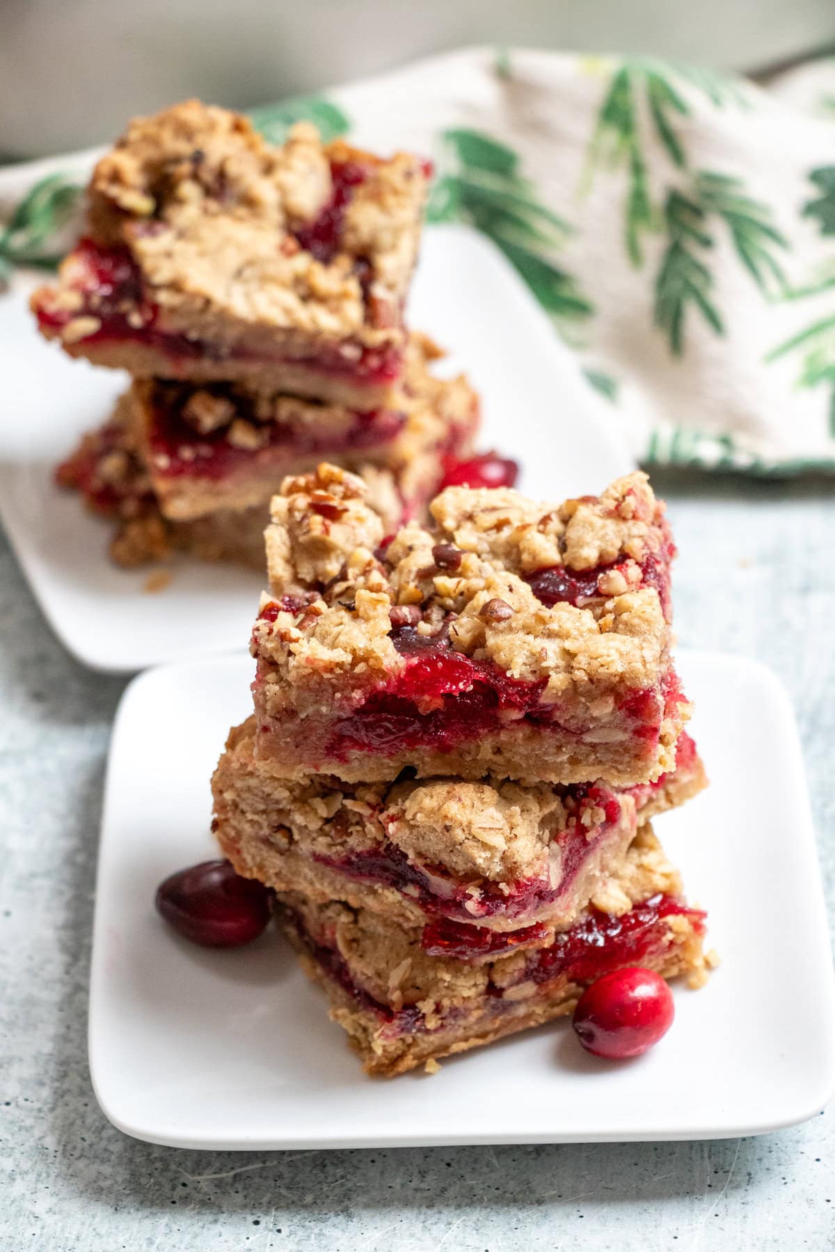 With a perfect balance of sweet and tart these scrumptious cranberry oat bars are the perfect holiday treat! The addition of chopped walnuts give them a nutty crunch that brings these yummy bars over the top. These bars can be made completely gluten-free and tastes as deliciously good!