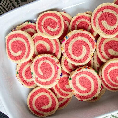With a delightful blend of buttery deliciousness and vibrant colors, and enhanced by the addition of either almond or peppermint flavors to make it even more delectable, our Holiday Pinwheel Cookies truly stand out! Elevate your holiday baking with this visually stunning treat that's not only easy to make but also perfect for sharing the magic of the season. Step-by-step photo instructions are included with the recipe.