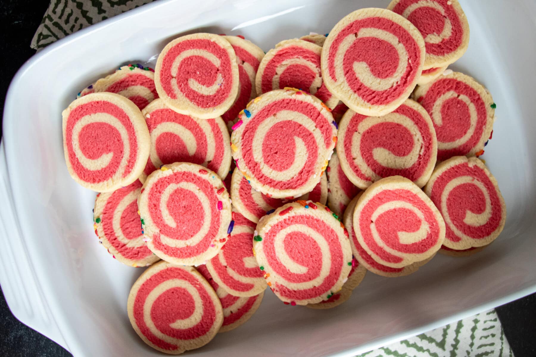 With a delightful blend of buttery deliciousness and vibrant colors, and enhanced by the addition of either almond or peppermint flavors to make it even more delectable, our Holiday Pinwheel Cookies truly stand out! Elevate your holiday baking with this visually stunning treat that's not only easy to make but also perfect for sharing the magic of the season. Step-by-step photo instructions are included with the recipe.