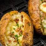 baked potatoes split with bacon and chives as topping