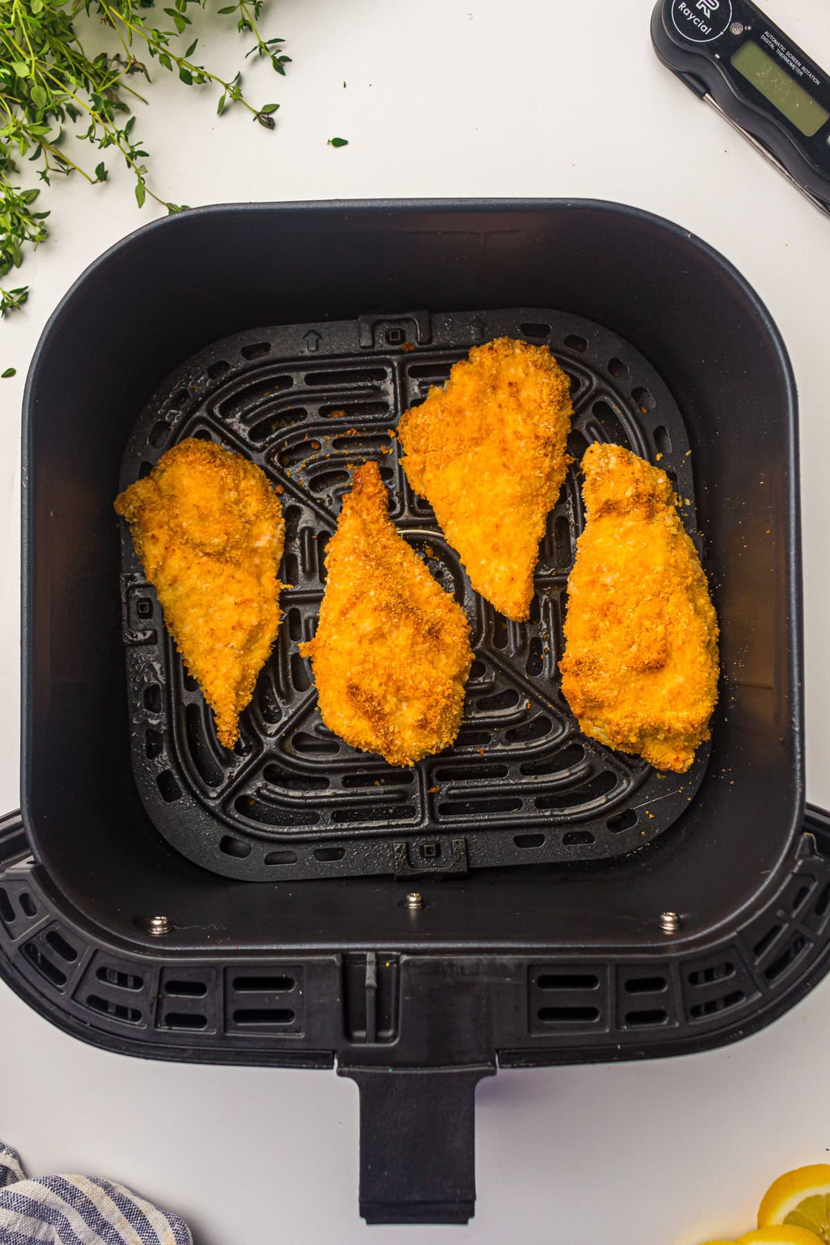 cooked chicken cutlets inside air fryer