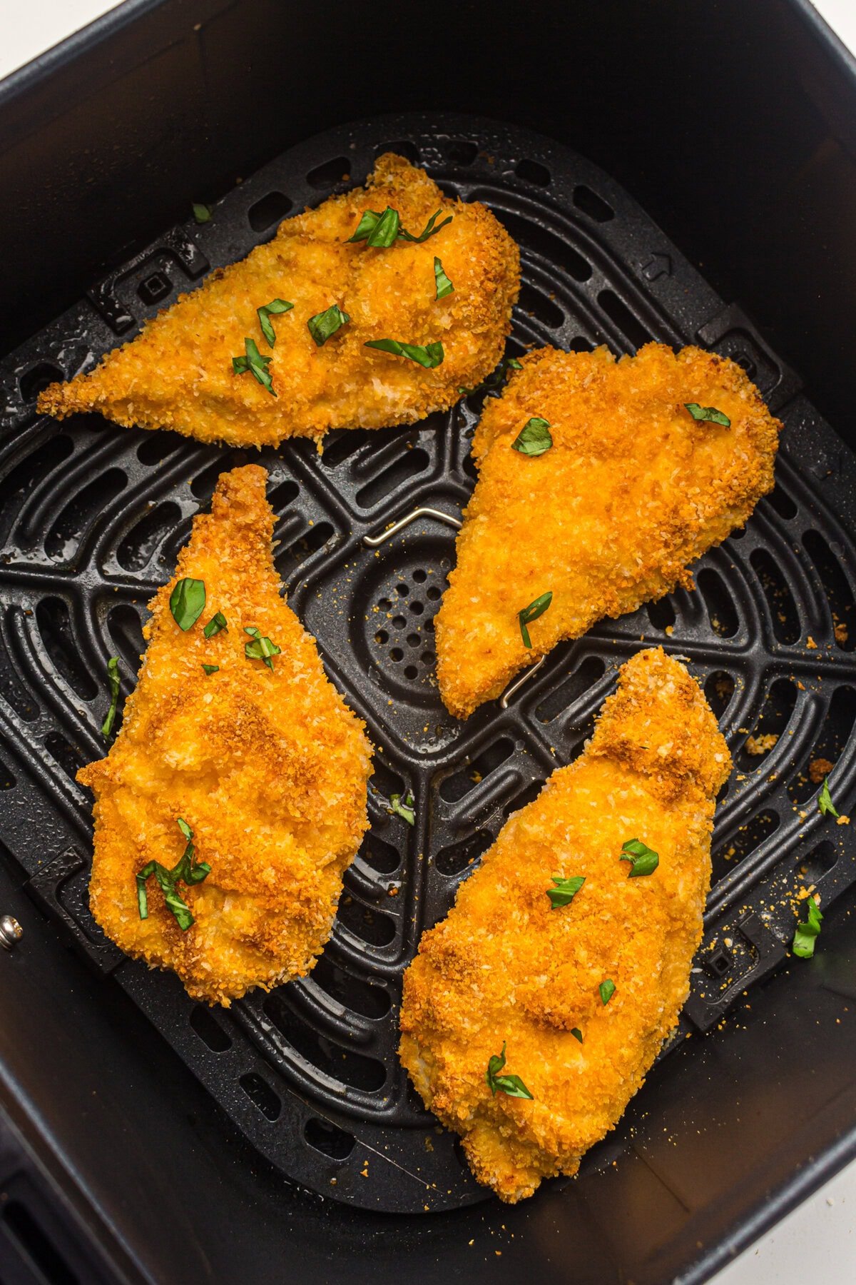cooked chicken cutlets inside air fryer