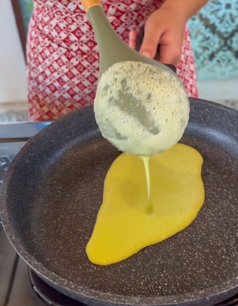 pouring batter over the pan
