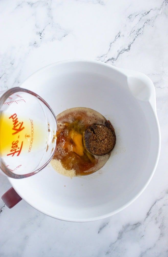 combining wet ingredients for spiced apple cider baked donuts
