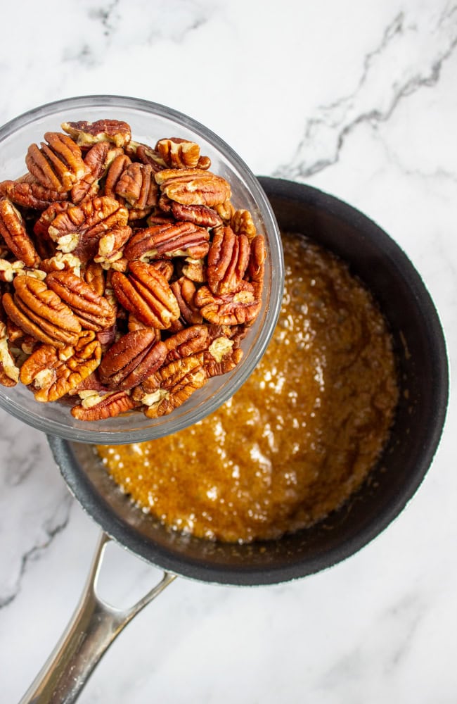 adding pecans to the melted butter