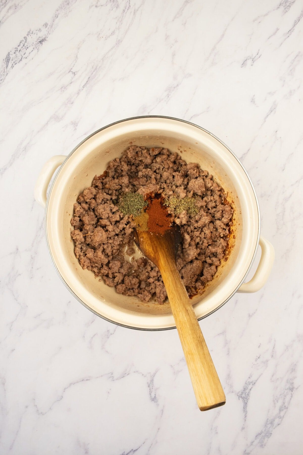 Add the ground beef (or lamb) and cook until browned, breaking it up as it cooks. Sprinkle in thyme, rosemary, cumin, and paprika. Let the spices bloom for 30 seconds to release their aroma.