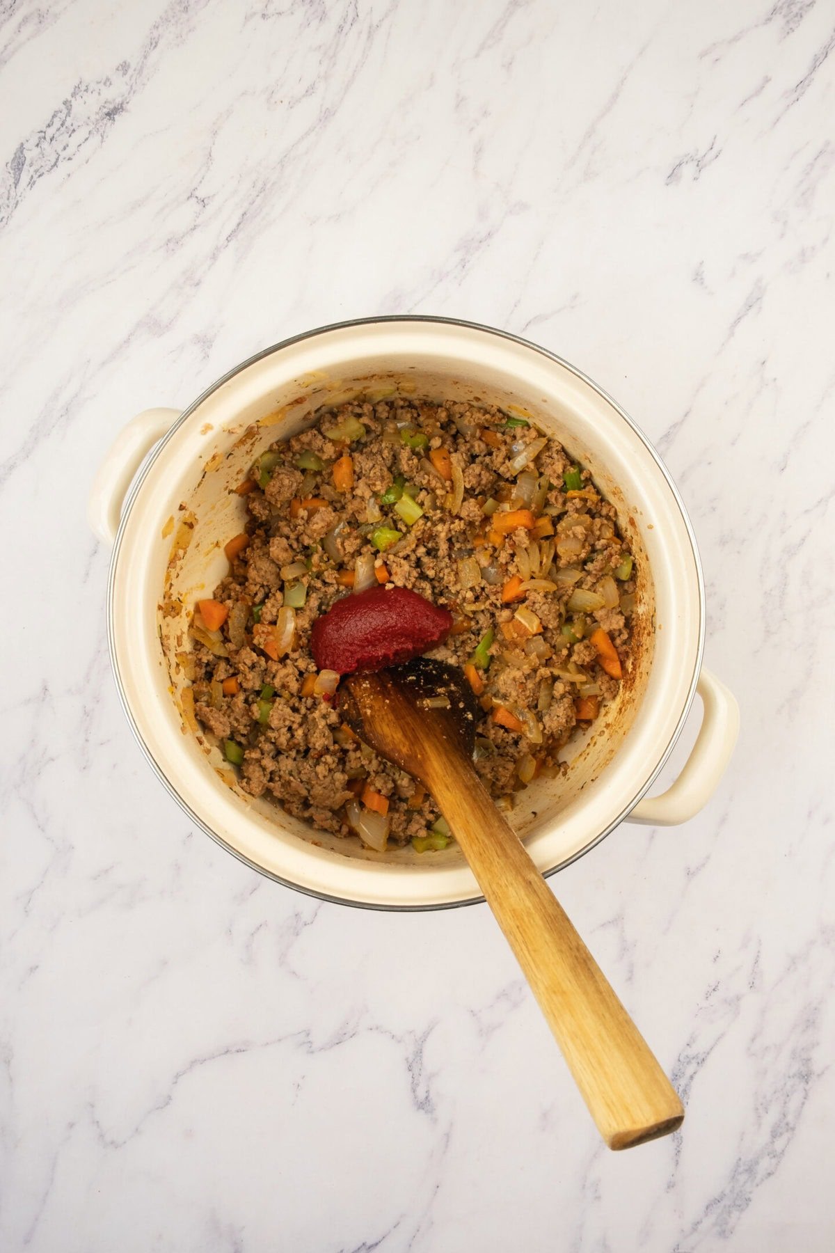Add tomato paste, salt, and pepper. Stir well and cook for another 1–2 minutes to concentrate the tomato flavor — this gives the soup a beautiful richness.