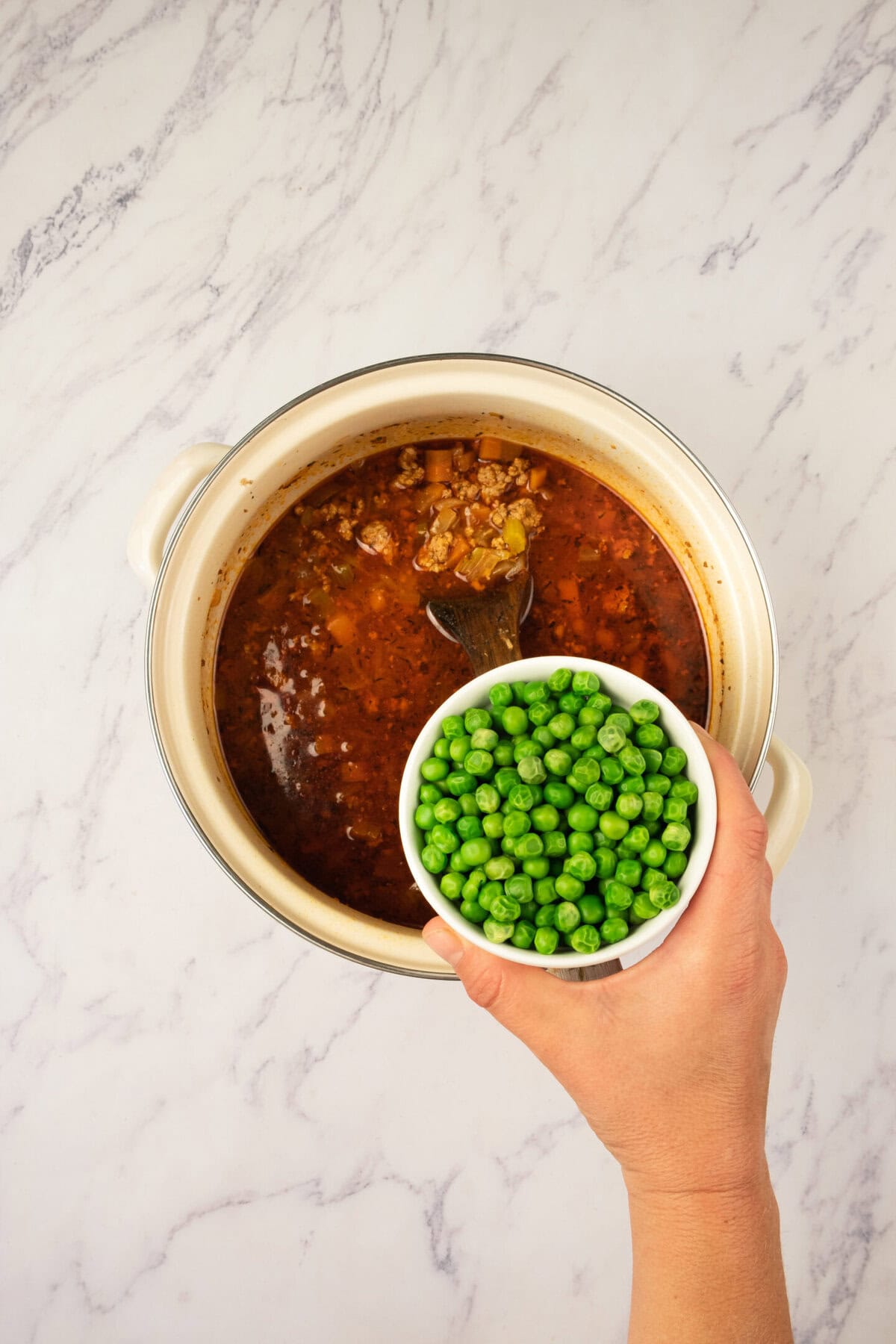 Add tomato paste, salt, and pepper. Stir well and cook for another 1–2 minutes to concentrate the tomato flavor — this gives the soup a beautiful richness.
