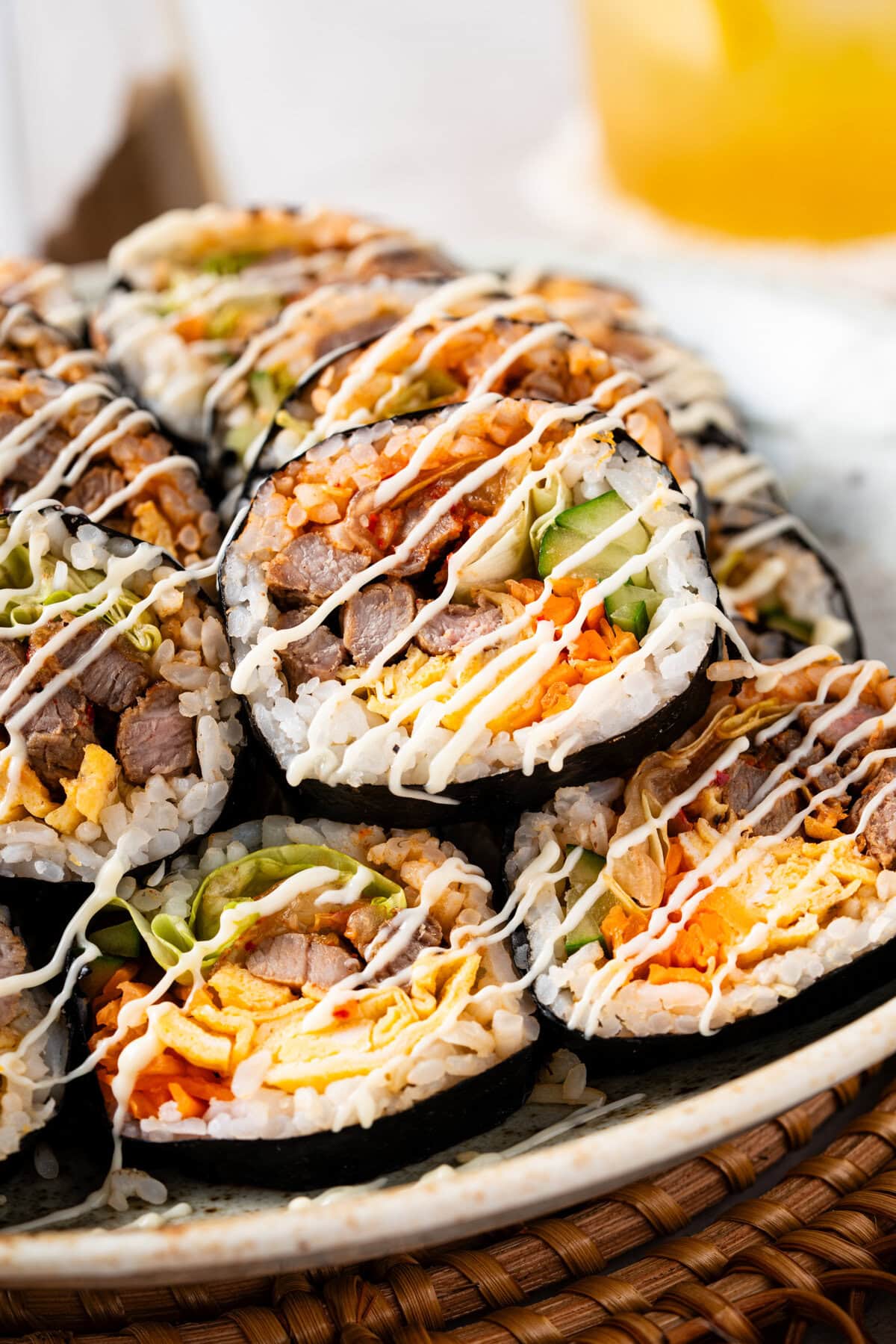 Bulgogi Kimbap with savory marinated beef, sesame rice, kimchi, egg, and crisp vegetables.