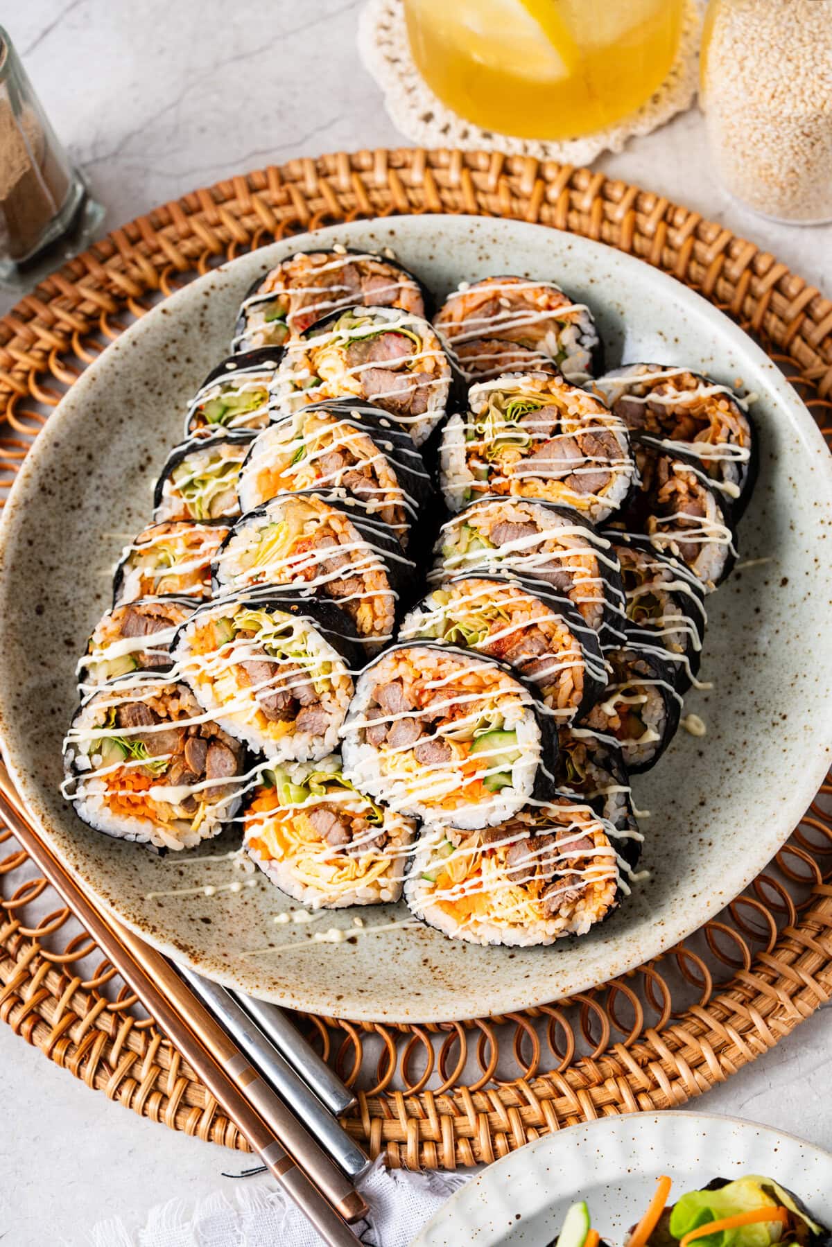 Bulgogi Kimbap with savory marinated beef, sesame rice, kimchi, egg, and crisp vegetables.